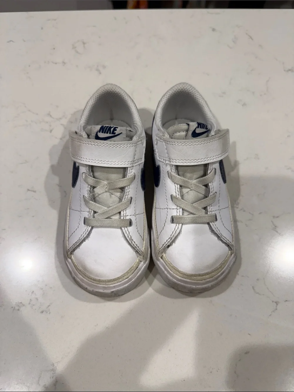 Nike Kids White Sneakers with Navy Swoosh and Velcro Strap
